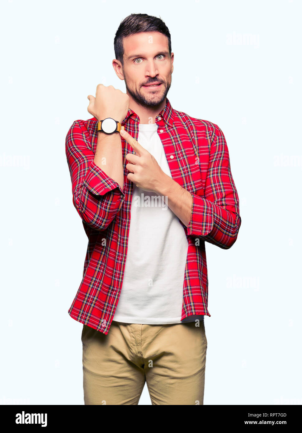 Handsome man wearing casual shirt In hurry pointing to watch time, impatience, upset and angry for deadline delay Stock Photo