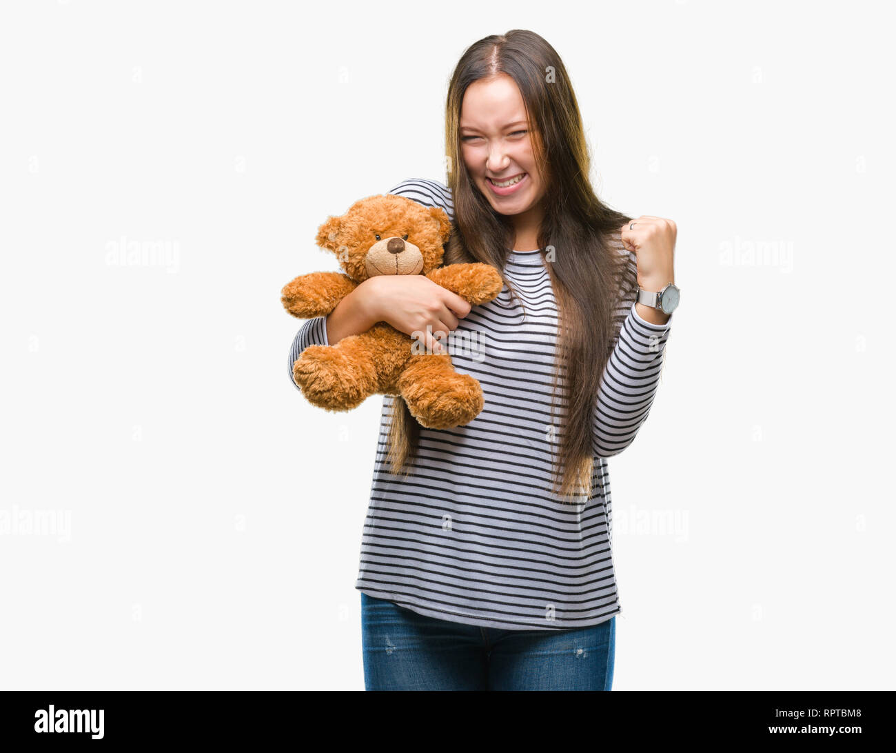Young caucasian woman holding teddy bear over isolated background ...