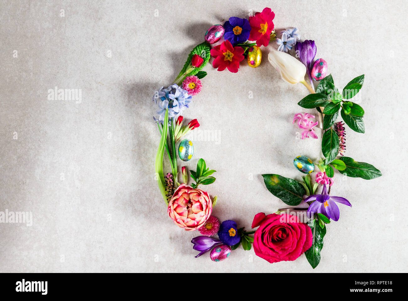 Easter minimal concept. Egg shape made from spring flowers on grey ...