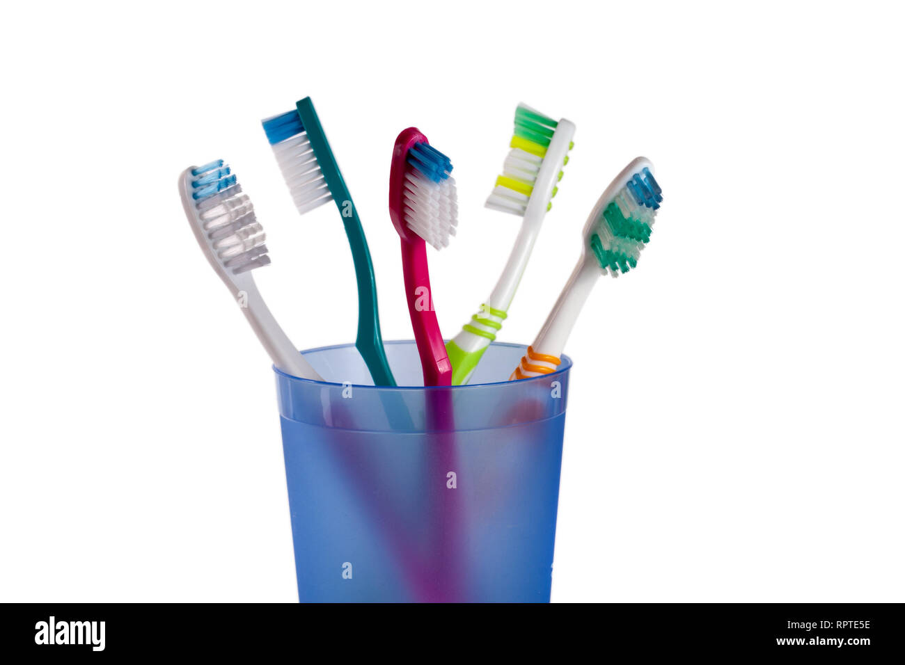 Toothbrushes in blue glass isolated on white background Stock Photo - Alamy