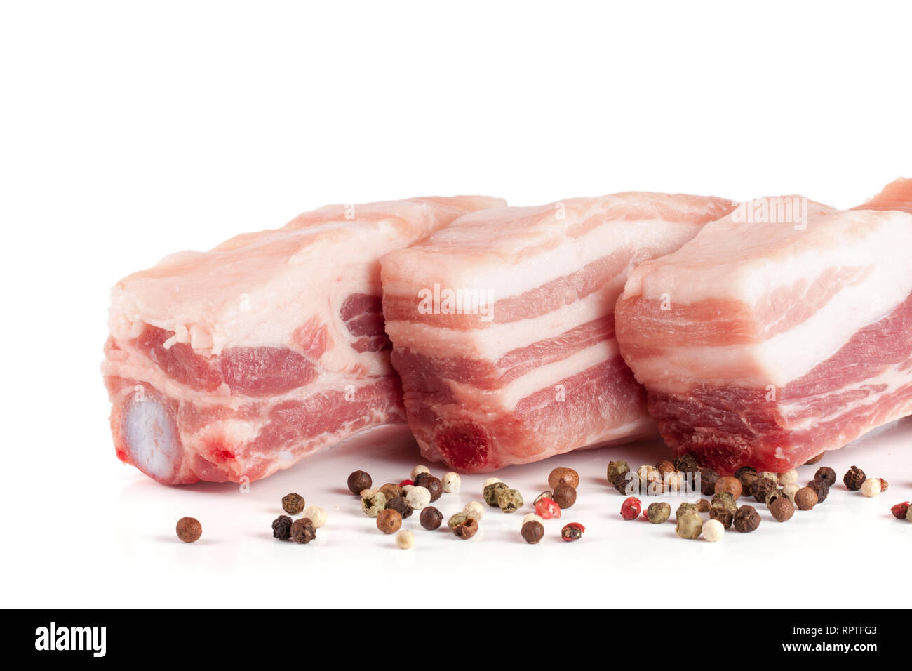 pieces of raw pork with peppercorn isolated on white background Stock ...