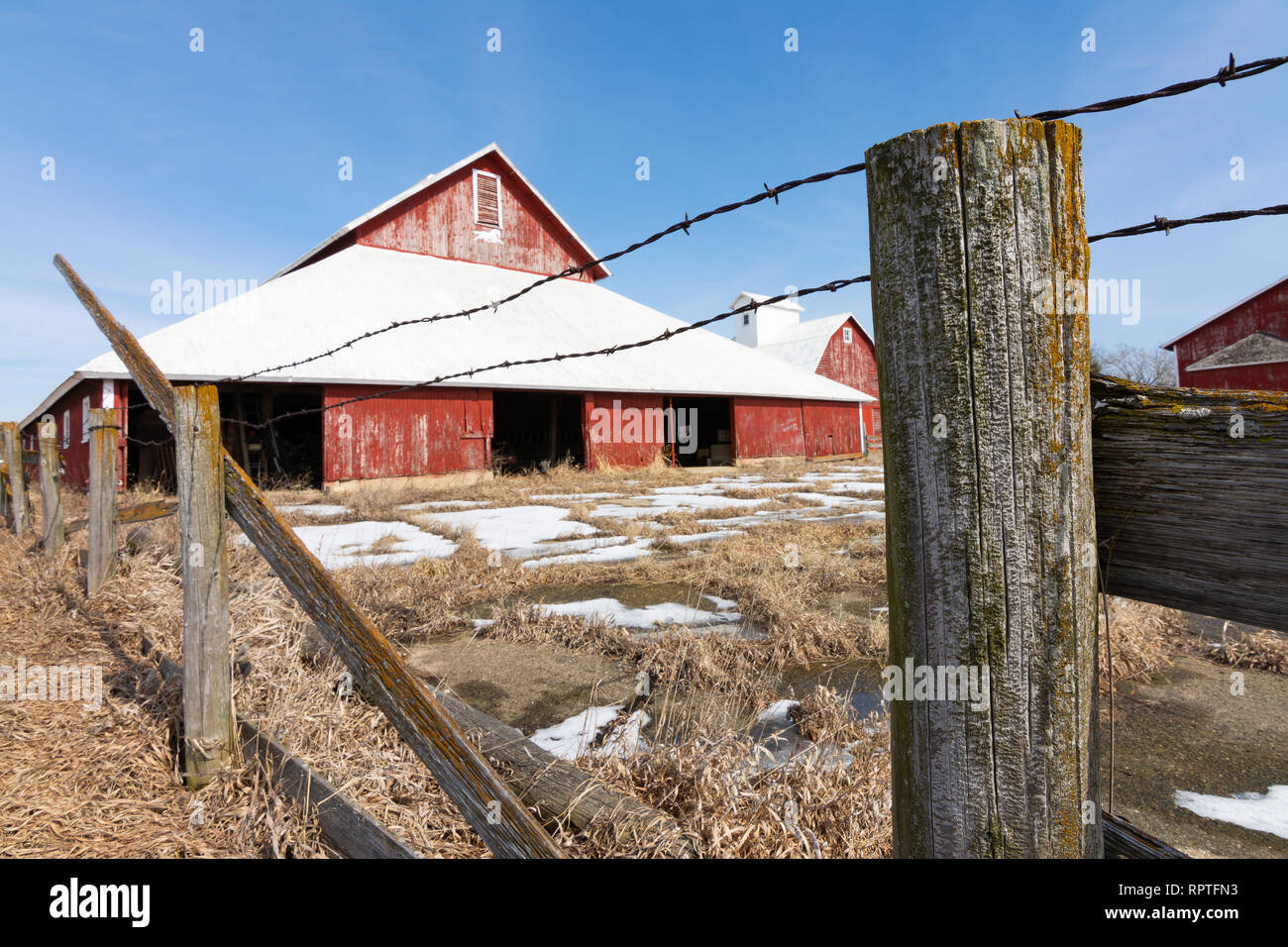 Old wooden fence with red barn in the background Stock Photo - Alamy