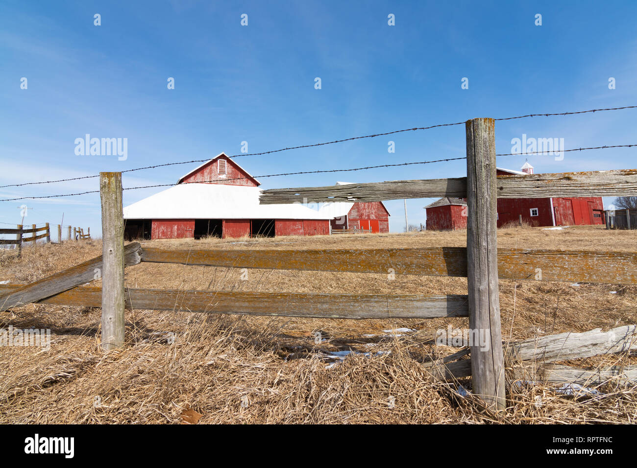 Old wooden fence with red barn in the background Stock Photo - Alamy