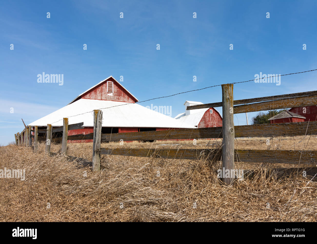 Old wooden fence with red barn in the background Stock Photo - Alamy