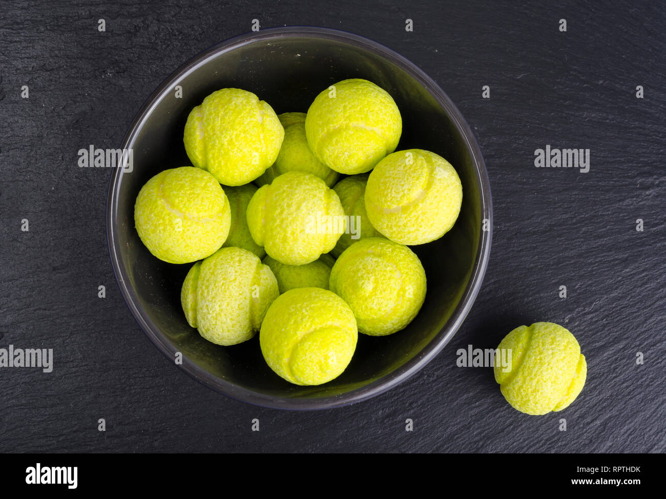Round balls of chewing candies on black background. Studio Photo Stock