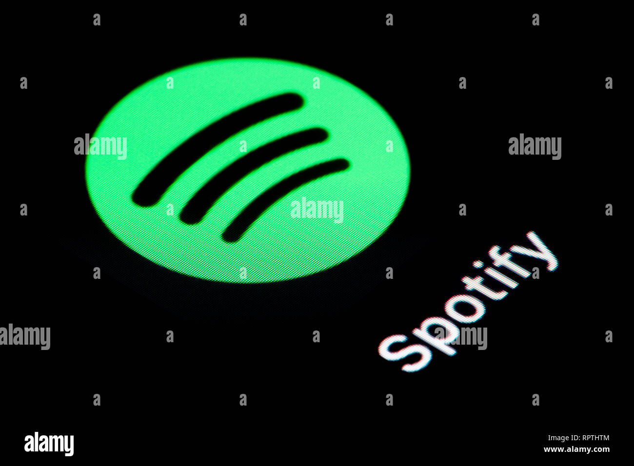 A close-up shot of the Spotify app icon, as seen on the screen of a smart phone (Editorial use only) Stock Photo