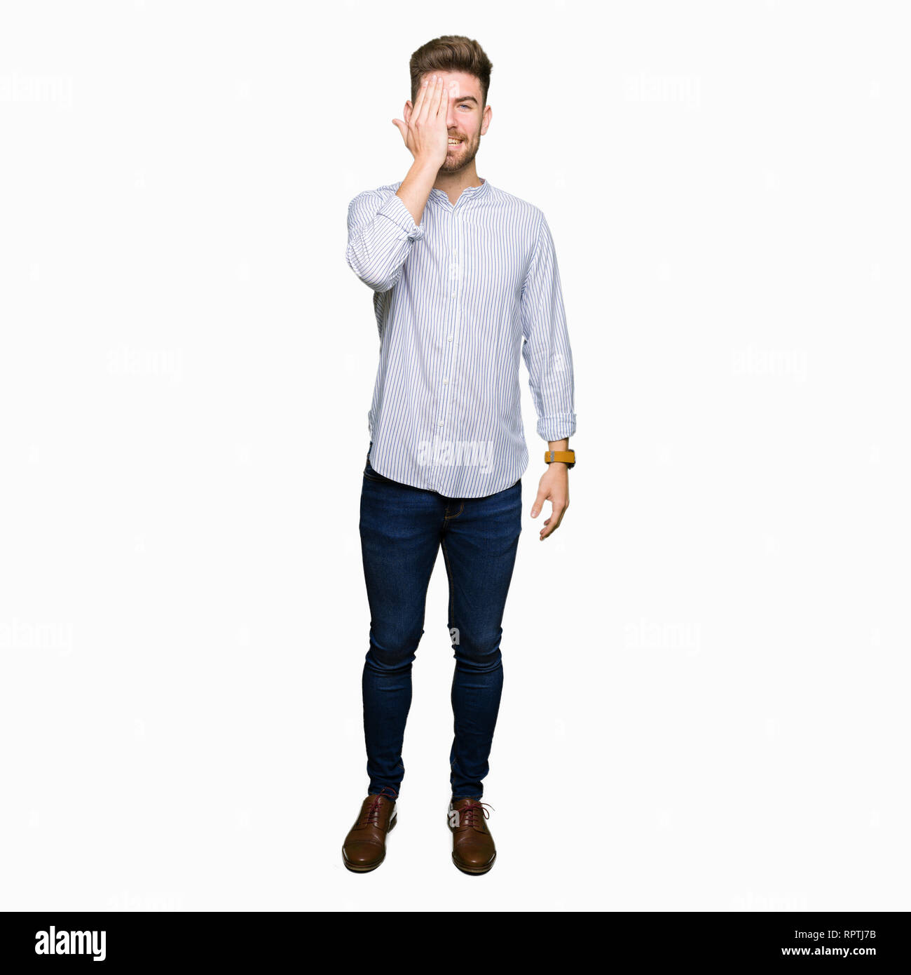 Young handsome man covering one eye with hand with confident smile on ...