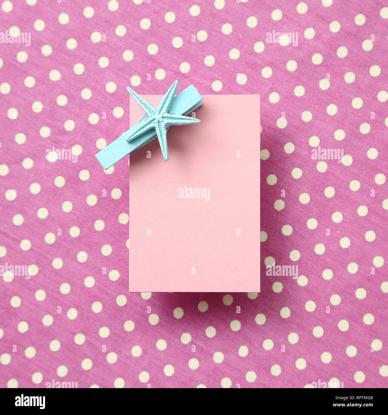Pink memo pad, sticky note on pink dot pattern fabric background Stock Photo