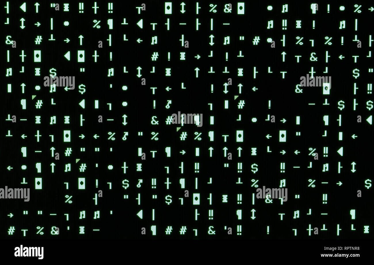 Computer monitor with many green random characters after the attack of  computer virus created by a hacker Stock Photo - Alamy