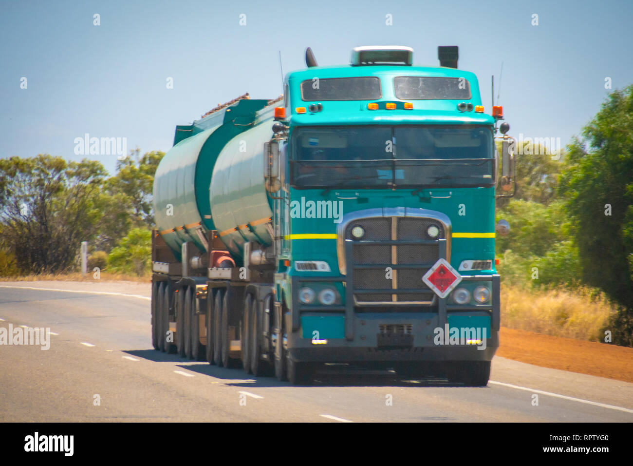 Long Road Train in the Australian Outback with trailer bringing fuel to gas station Stock Photo