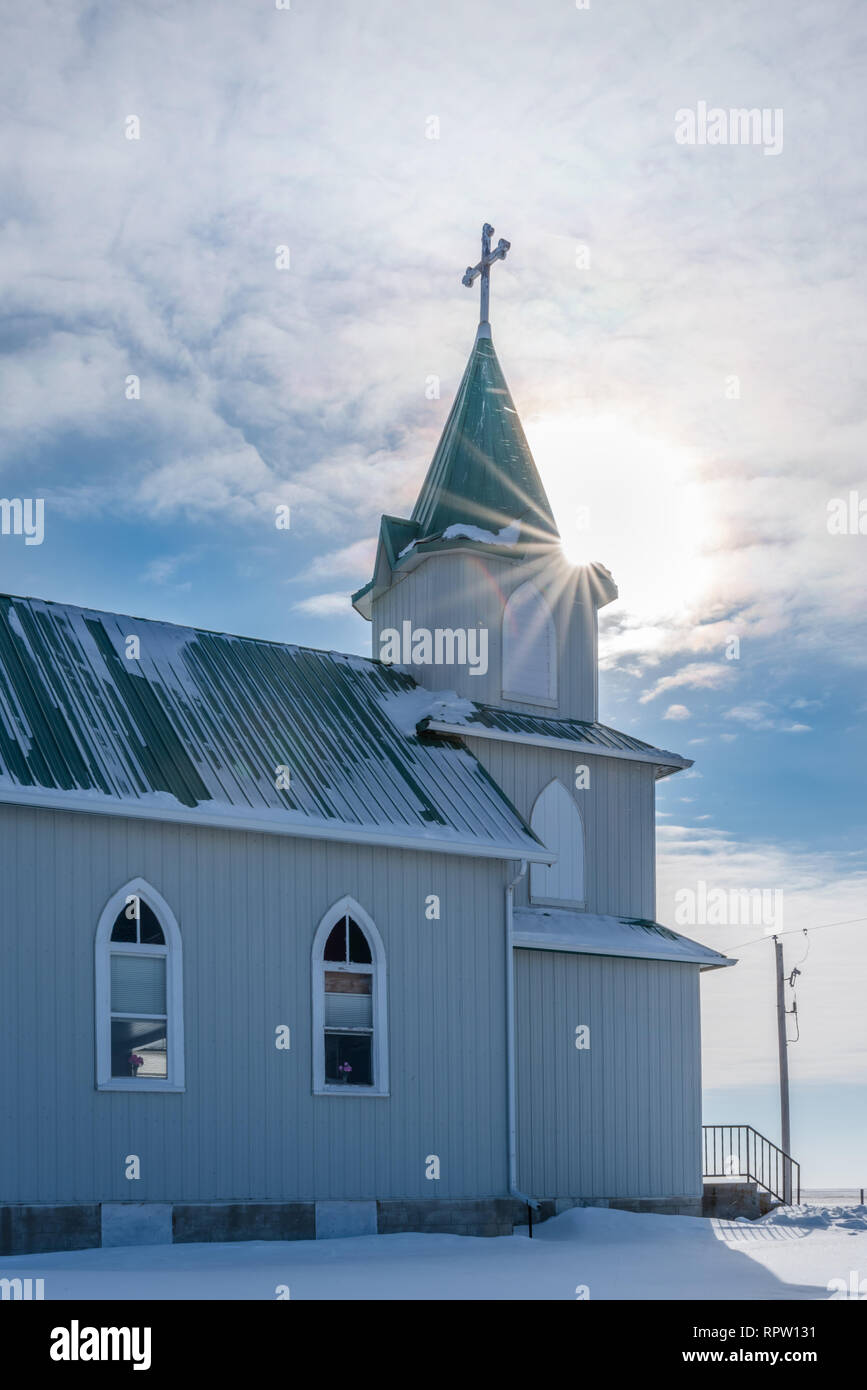Sunburst over the steeple of the historic Peace Lutheran Church on the prairies in Saskatchewan Stock Photo
