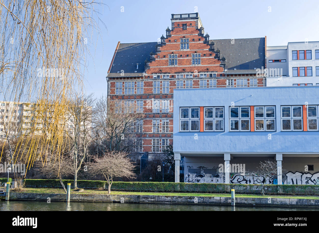 Spree river embankment Holsteiner Ufer in a city district Hansaviertel with buildings of a  Gymnasium school in Berlin, Germany Stock Photo