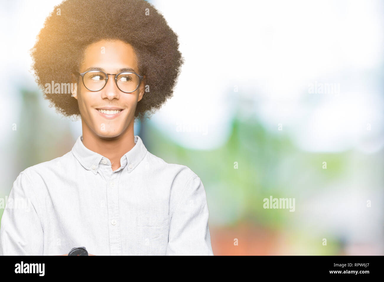 Young African American Man With Afro Hair Wearing Glasses Smiling