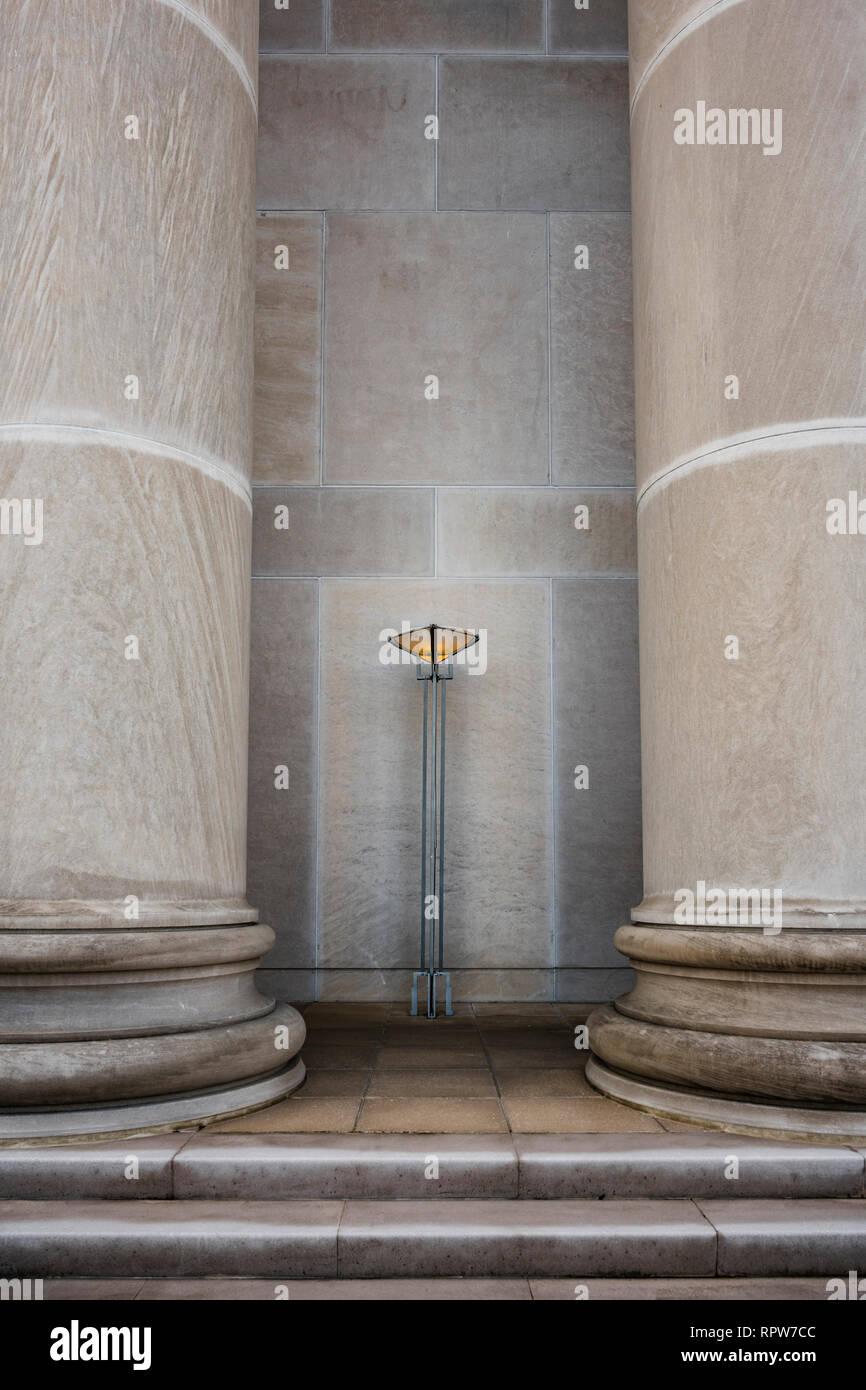Greek revival architecture artistic standing light sconce or fixture between two massive concrete or marble columns in Montgomery Alabama, USA. Stock Photo