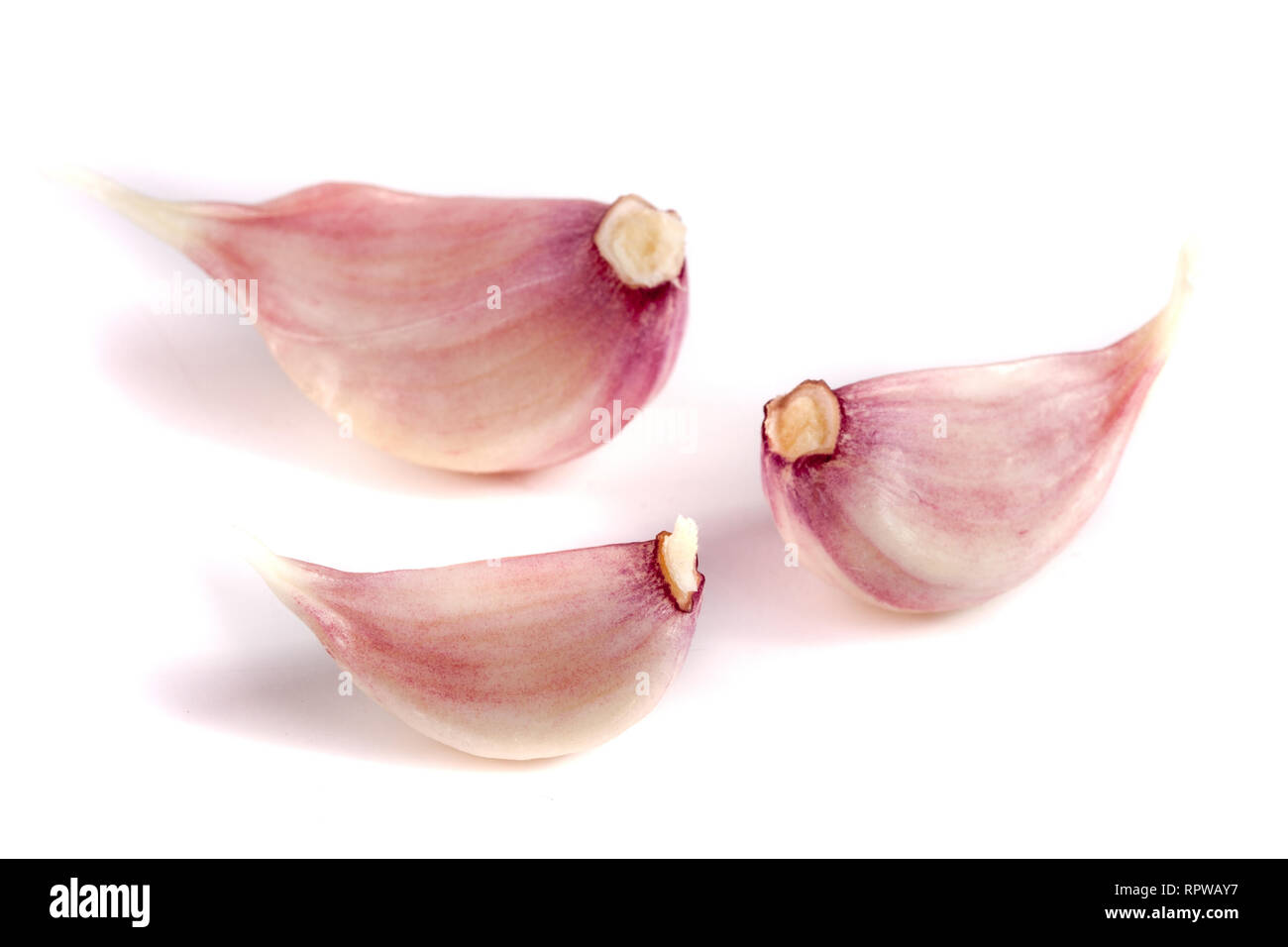 Three garlic cloves isolated on white background Stock Photo