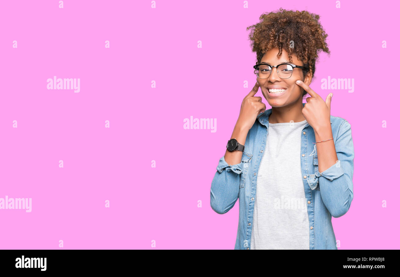 Beautiful young african american woman wearing glasses over isolated ...