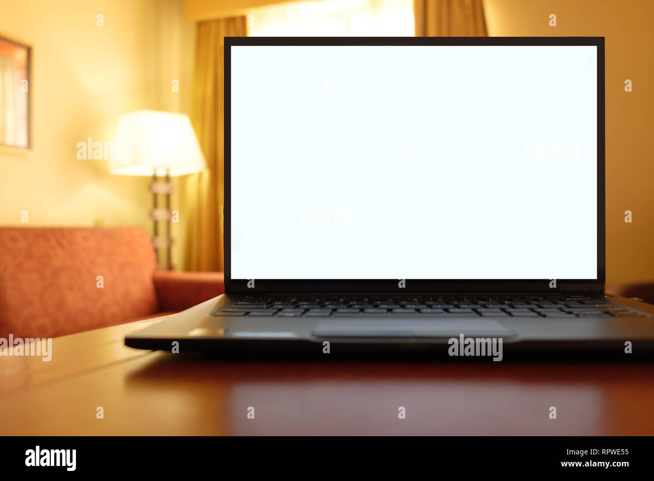 Laptop computer on desk in cozy hotel room Stock Photo Alamy