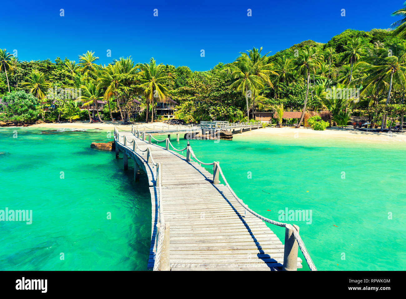 Jetty to a tropical beach Stock Photo