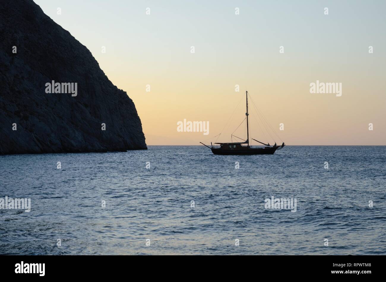 Boat in the sunset in Santorini – Greek island Stock Photo - Alamy