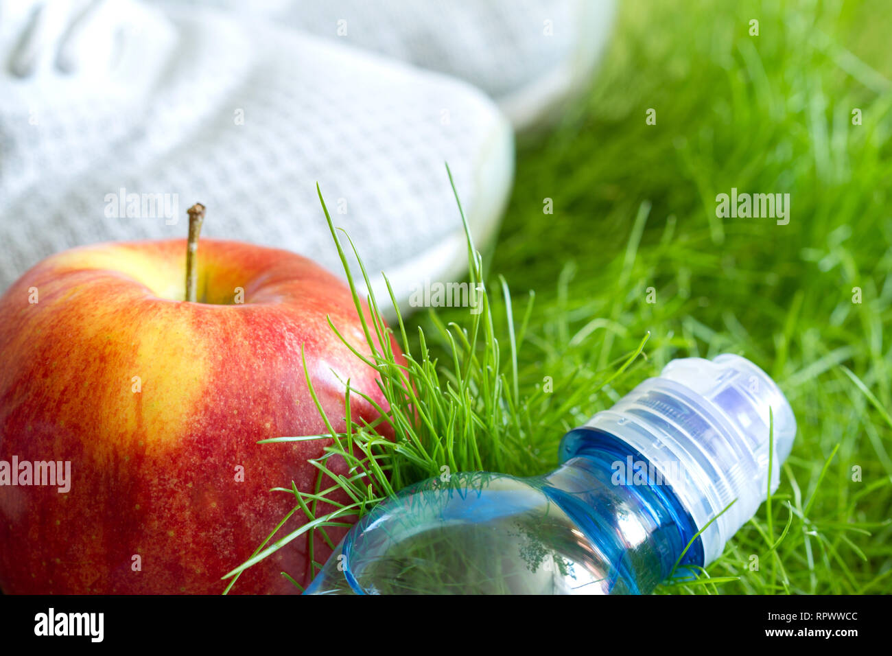 Jogging and sport active livestyle concept with sneakers and healthy food outdoor on grass Stock Photo