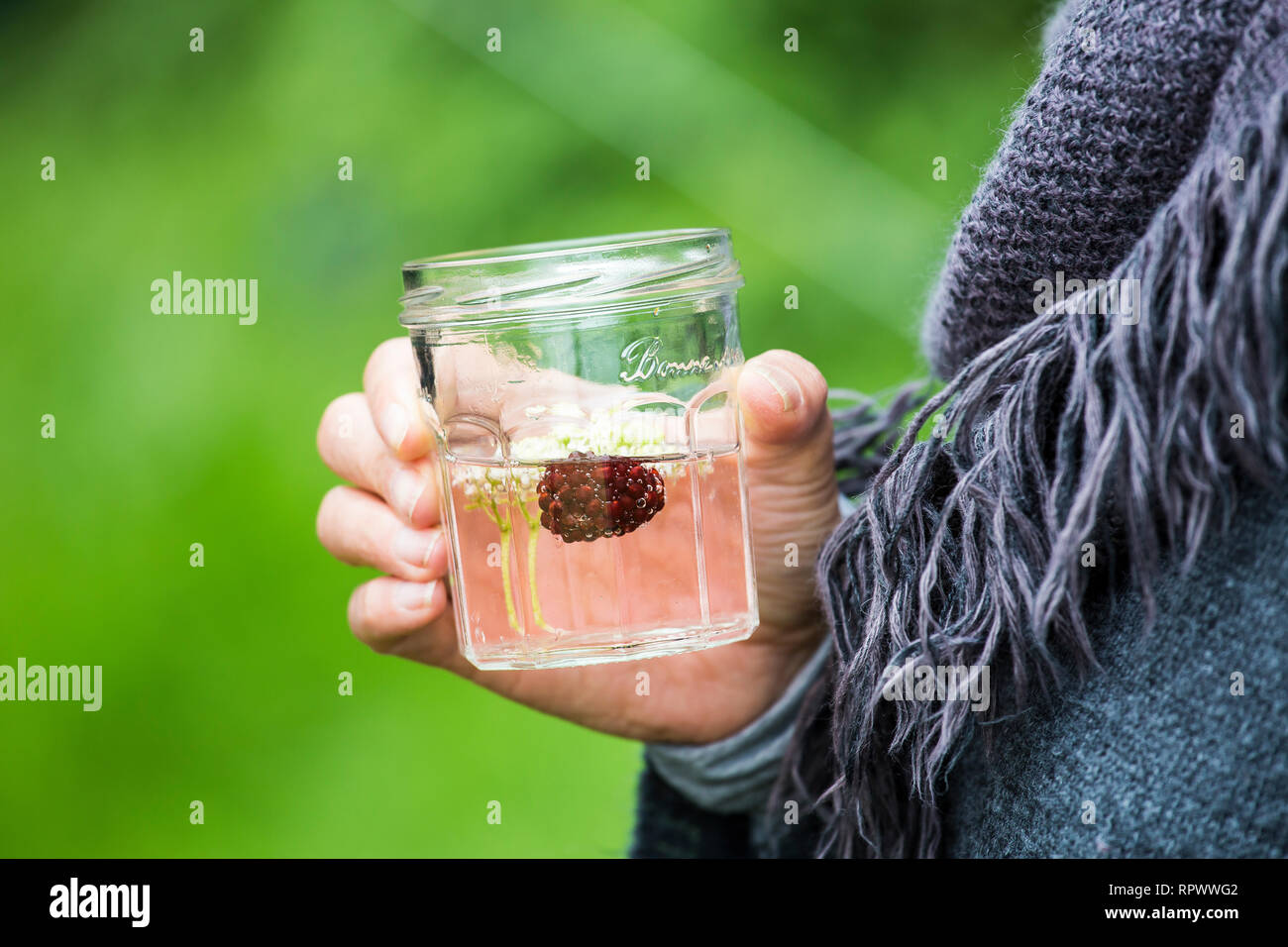 Rustic homemade country drink of elderflower cordial served in jam jar, Kent, UK Stock Photo