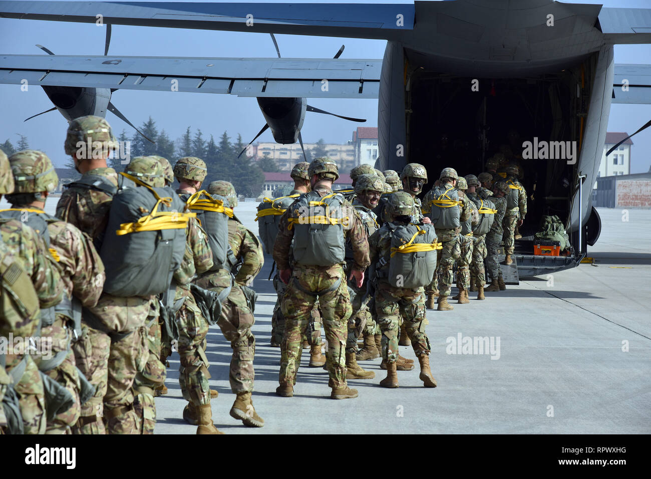 U.S. Army Paratroopers assigned to the 173rd Airborne Brigade, prepare to board a U.S. Air Force C-130 Hercules aircraft from the 86th Air Wing at Aviano Air Base, in preparation for airborne operations onto Juliet Drop Zone, Pordenone, Italy Feb. 21, 2019. The 173rd Airborne Brigade is the U.S. Army Contingency Response Force in Europe, capable of projecting ready forces anywhere in the U.S. European, Africa or Central Commands' areas of responsibility. (U.S. Army Photo by Paolo Bovo) Stock Photo