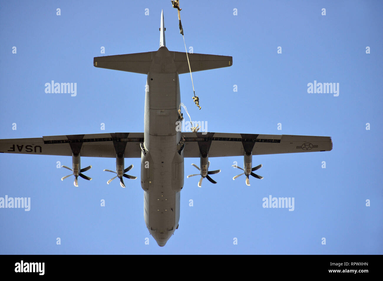 U.S. Army Paratroopers, assigned to the 173rd Brigade Support Battalion, 173rd Airborne Brigade, exit a U.S. Air Force C-130 Hercules aircraft from the 86th Air Wing at Juliet Drop Zone, Pordenone, Italy, Feb. 21, 2019 during airborne operation. The 173rd Airborne Brigade is the U.S. Army Contingency Response Force in Europe, capable of projecting ready forces anywhere in the U.S. European, Africa or Central Commands' areas of responsibility. (U.S. Army Photo by Paolo Bovo) Stock Photo
