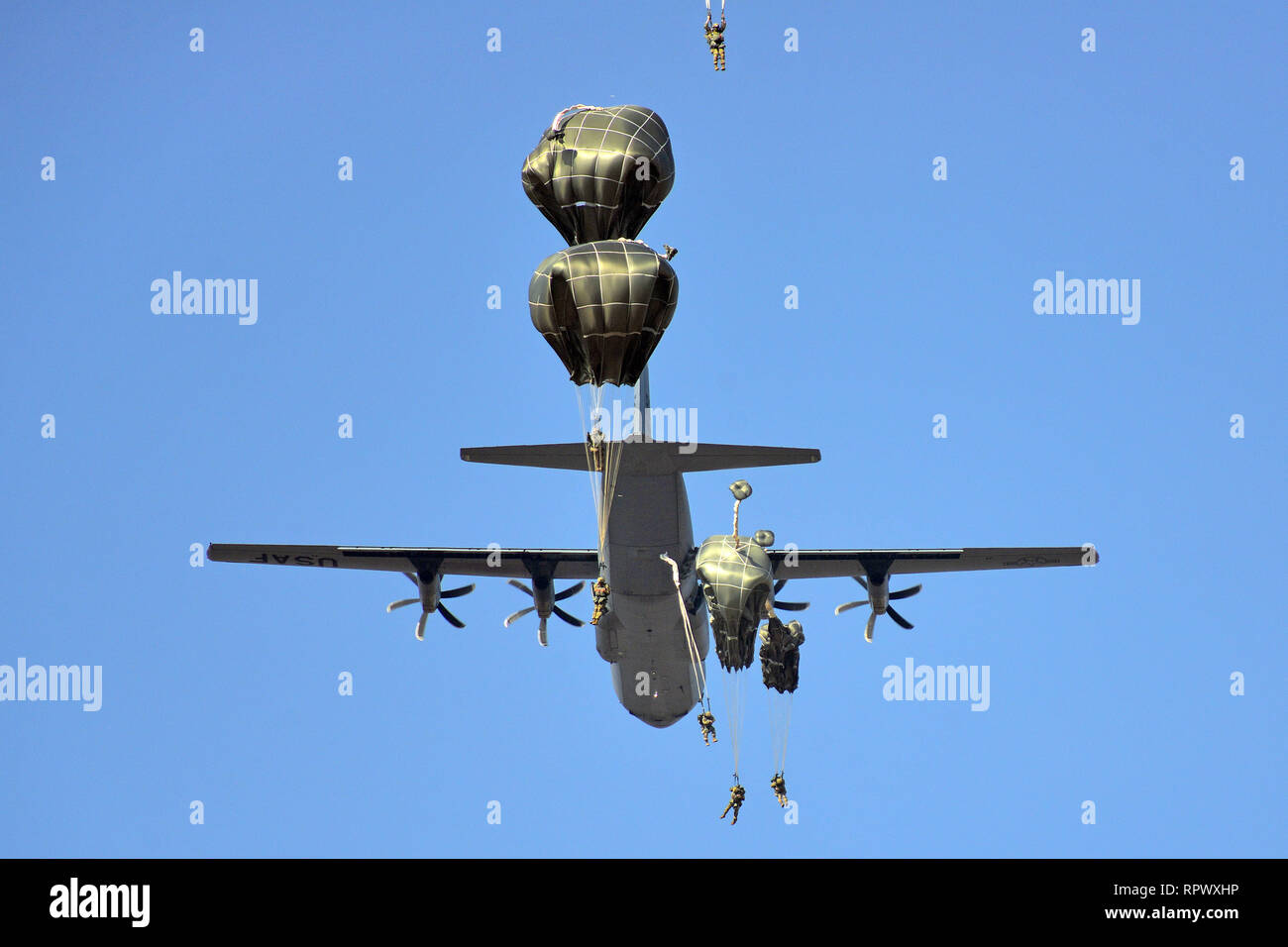 U.S. Army Paratroopers, assigned to the 173rd Brigade Support Battalion, 173rd Airborne Brigade, exit a U.S. Air Force C-130 Hercules aircraft from the 86th Air Wing at Juliet Drop Zone, Pordenone, Italy, Feb. 21, 2019 during airborne operation. The 173rd Airborne Brigade is the U.S. Army Contingency Response Force in Europe, capable of projecting ready forces anywhere in the U.S. European, Africa or Central Commands' areas of responsibility. (U.S. Army Photo by Paolo Bovo) Stock Photo