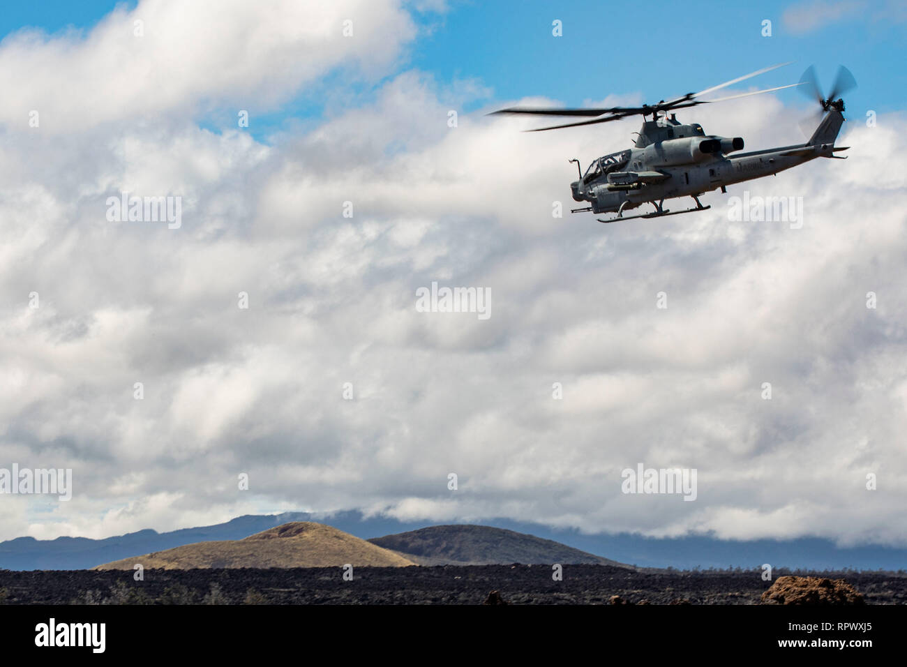 A U.S. Marine Corps AH-1Z Viper helicopter assigned to Marine Light Attack Helicopter Squadron (HMLA) 367, lifts off during a live fire exercise at Pohakuloa Training Area (PTA), Hawaii, Feb. 21, 2019. HMLA-367 provided close air support firing missiles and machine guns, as well as working with U.S. Air Force A-10 Thunderbolt II fighter aircraft to improve mission readiness and interoperability. (U.S. Marine Corps photo by Sgt. Jesus Sepulveda Torres) Stock Photo