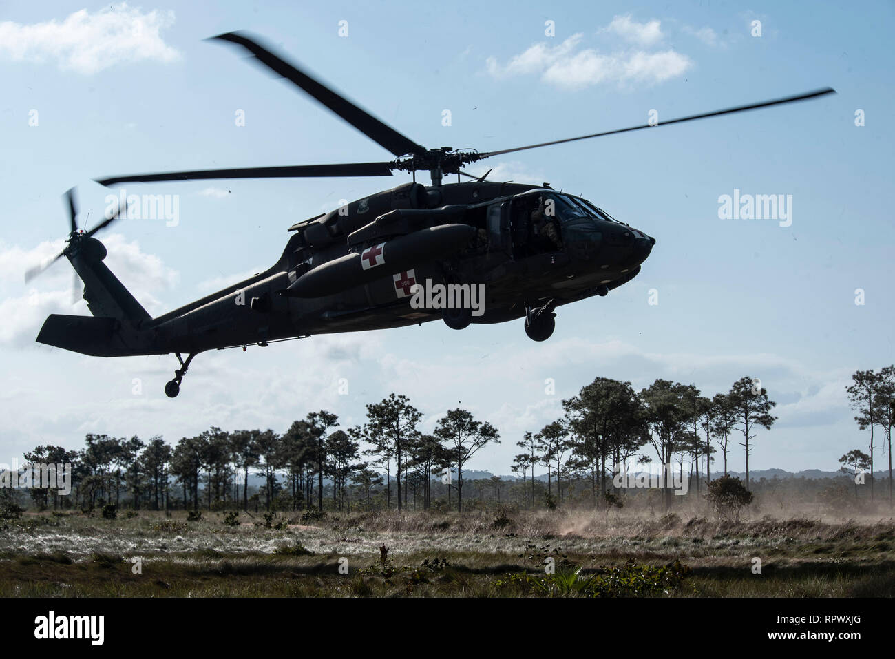 The 228th Aviation Regiment performs aerial gunnery training at a range in Belize, Feb. 12, 2019. During the training, 228th Soldiers qualified on the M-240H Machine Gun in either the Blackhawk or the CH-47 Chinook to maintain their combat capabilities. During the exercise, the regiment also planned out air assaults with their Belizean and British counterparts to provide an opportunity for the three countries to come together and practice coordinating operations with the other armed forces. (U.S. Air Force photo by Senior Airman Destinee Sweeney) Stock Photo