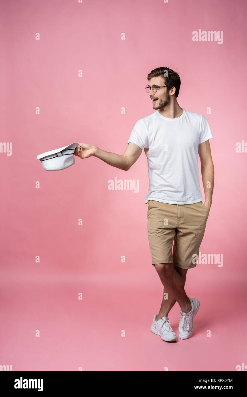 Happy Attractive Young Man Holding Hat And Asking For Money - 