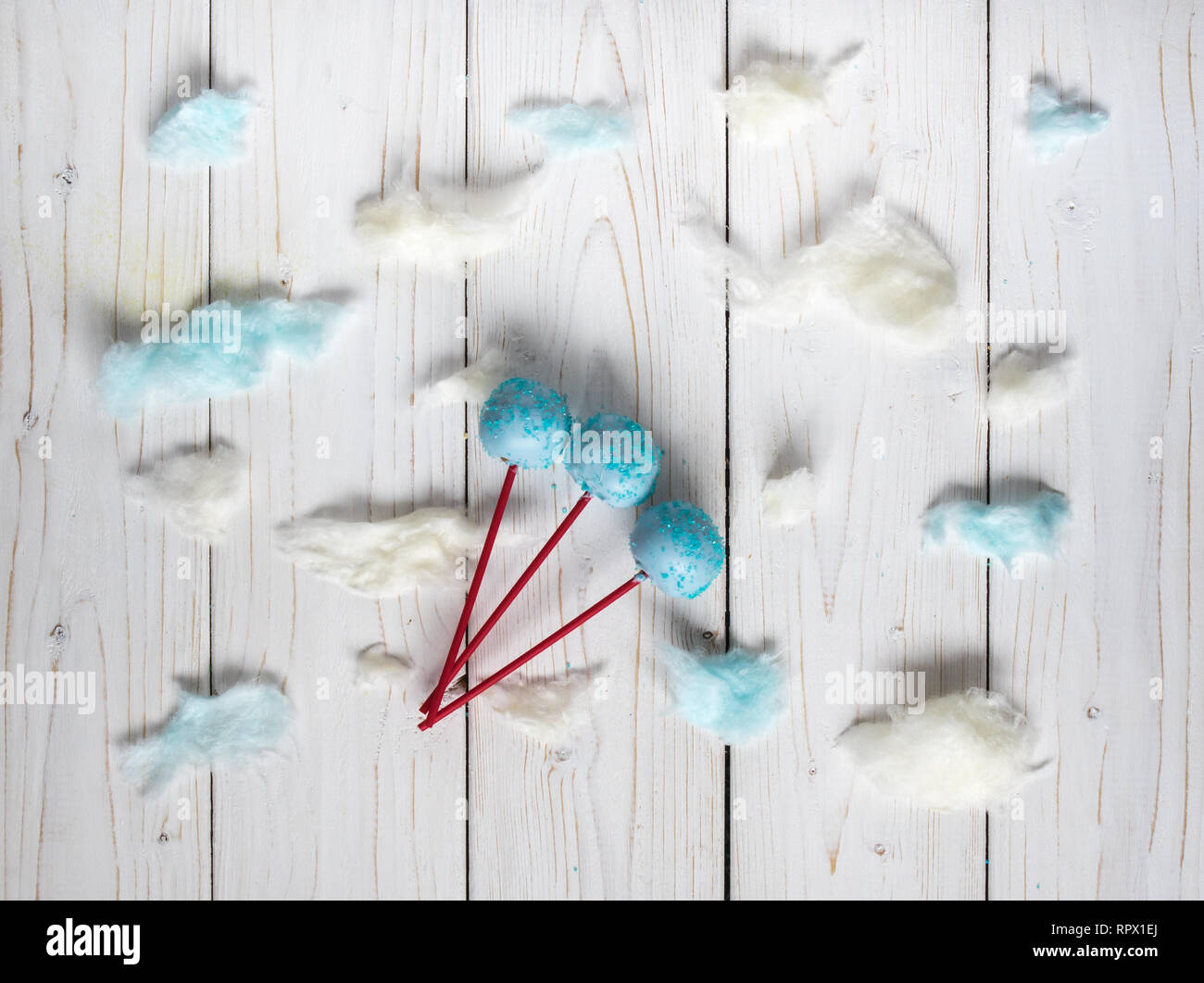 Blue cakepops among the candy-floss clouds, white background Stock Photo