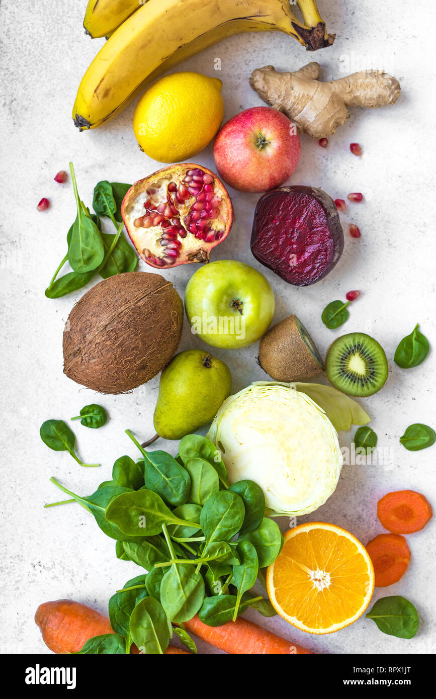 Colorful fruits and vegetables on a white table. Juice and smoothie ingredients. Healthy clean eating, detox, diet concept. Stock Photo