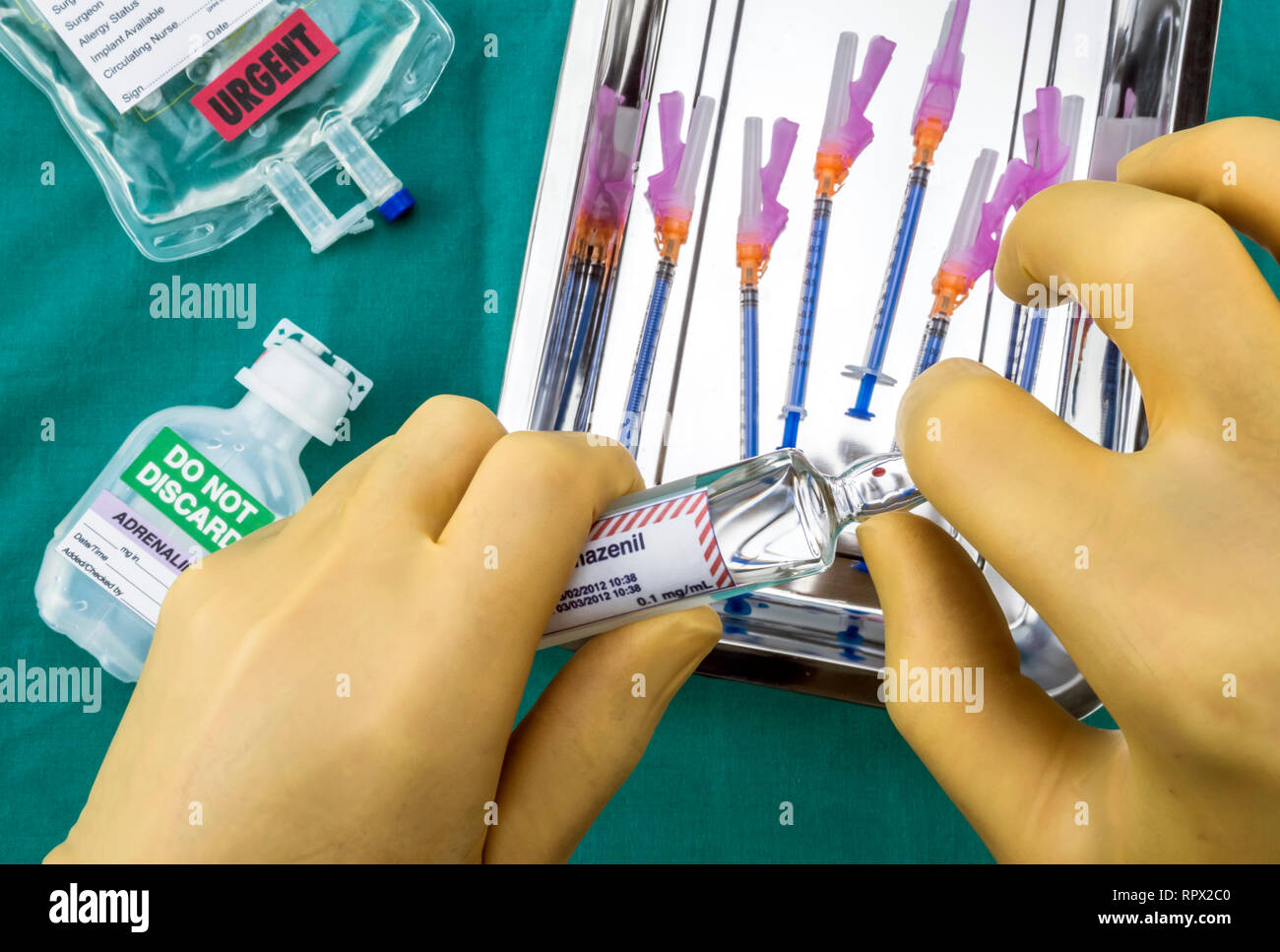 Nurse preparing hospital medication, Opening glass ampoule with