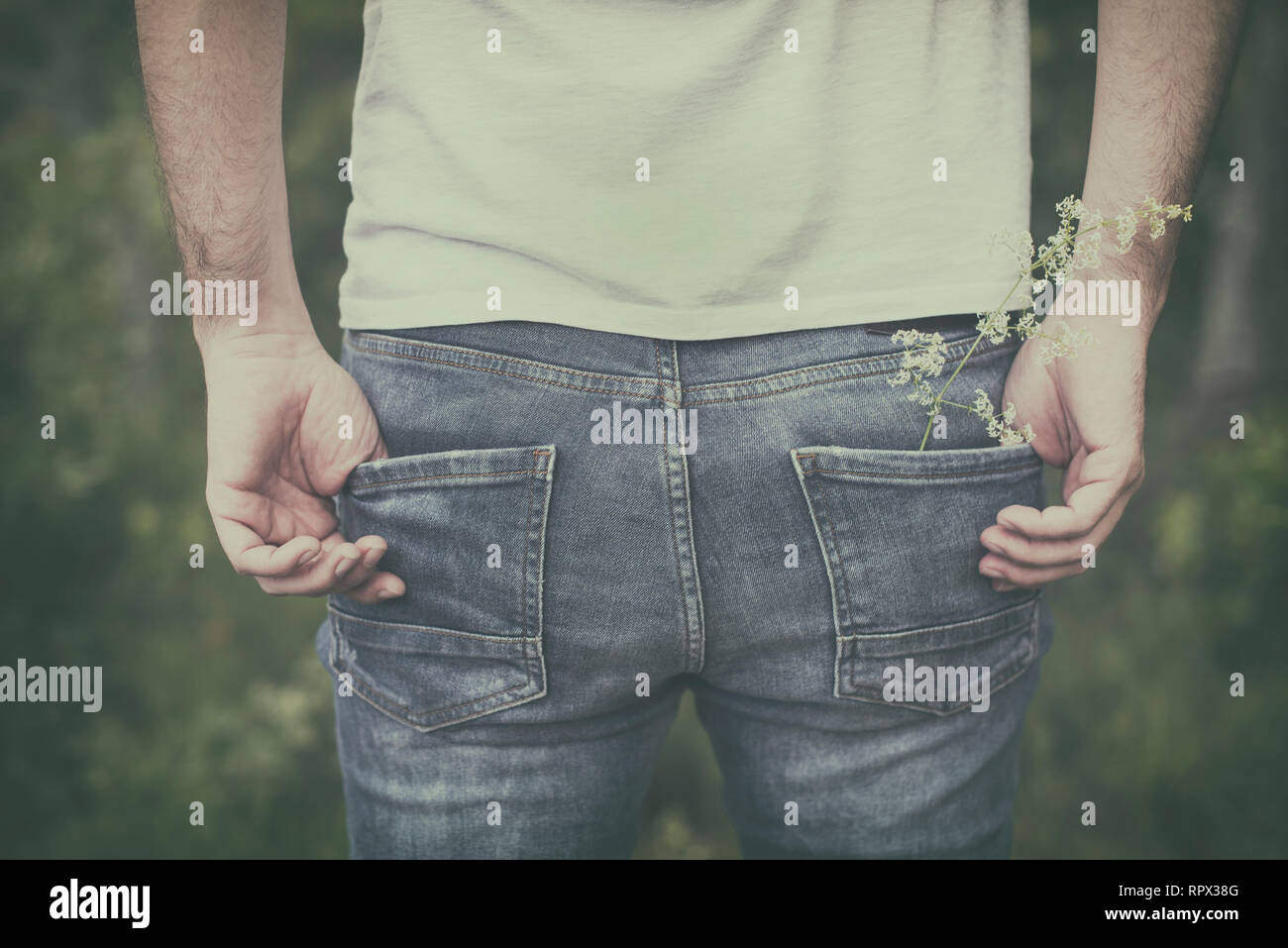 Close-up of a man with his hands in his pockets wearing jeans Stock Photo