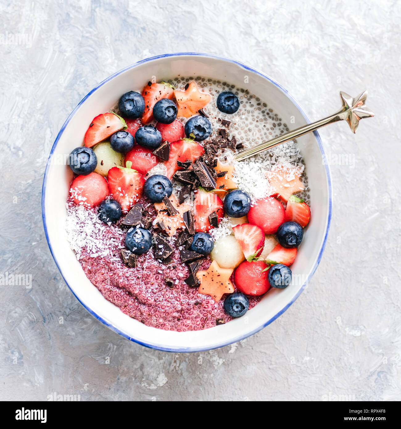 Chia pudding bowl with fruit, coconut and chocolate Stock Photo