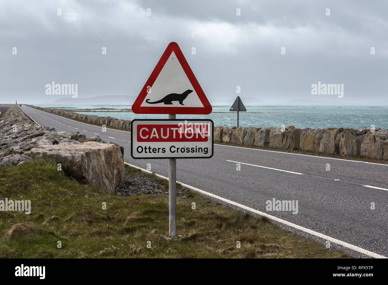 'Caution Otters Crossing' road sign on the approach to the causeway from South Uist to Eriskay, Outer Hebrides, Scotland. Stock Photo