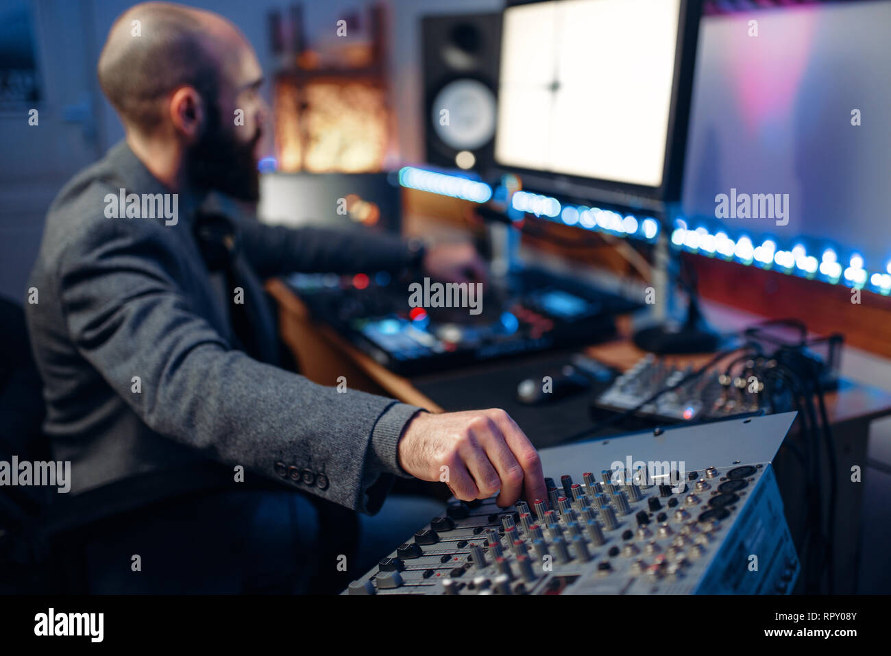 Sound operator at remote control panel in audio recording studio. Musician  at the mixer, professional music mixing Stock Photo - Alamy