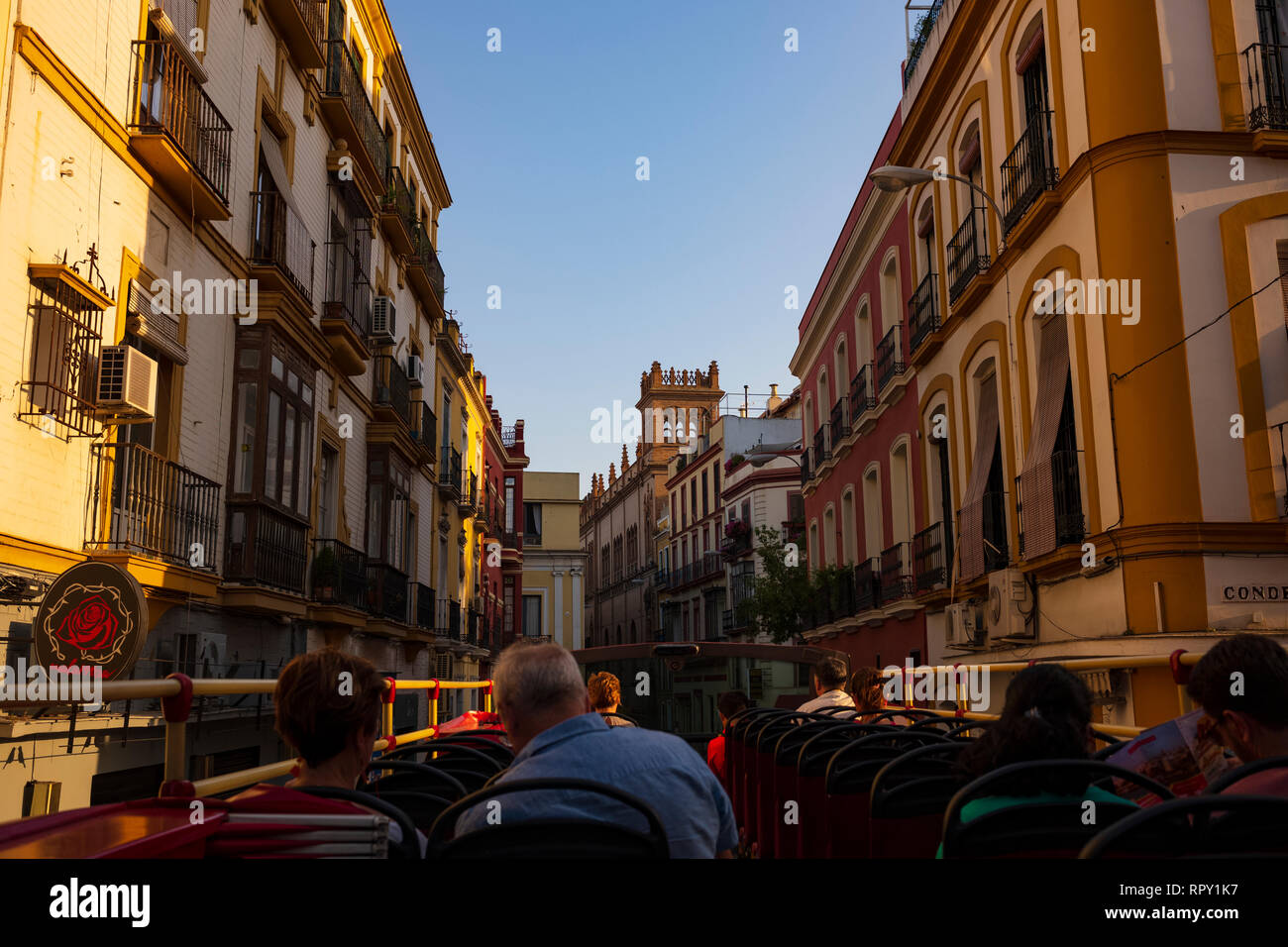Tourist aboard an open air, doubledeck tour bus, driving around