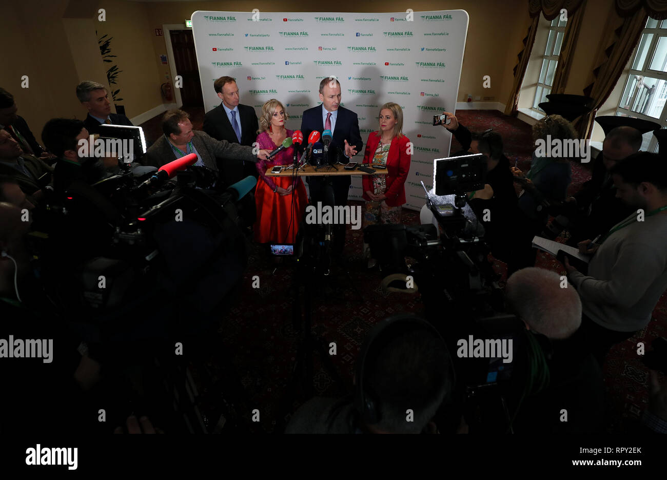 Fianna Fail leader Micheal Martin (centre) speaks to the press during his party's annual conference at the Citywest Hotel in Dublin. Stock Photo