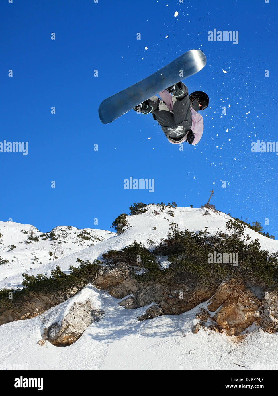 Snowboarding Snowboard Snowboarder at jump mountains at sunny day Stock Photo