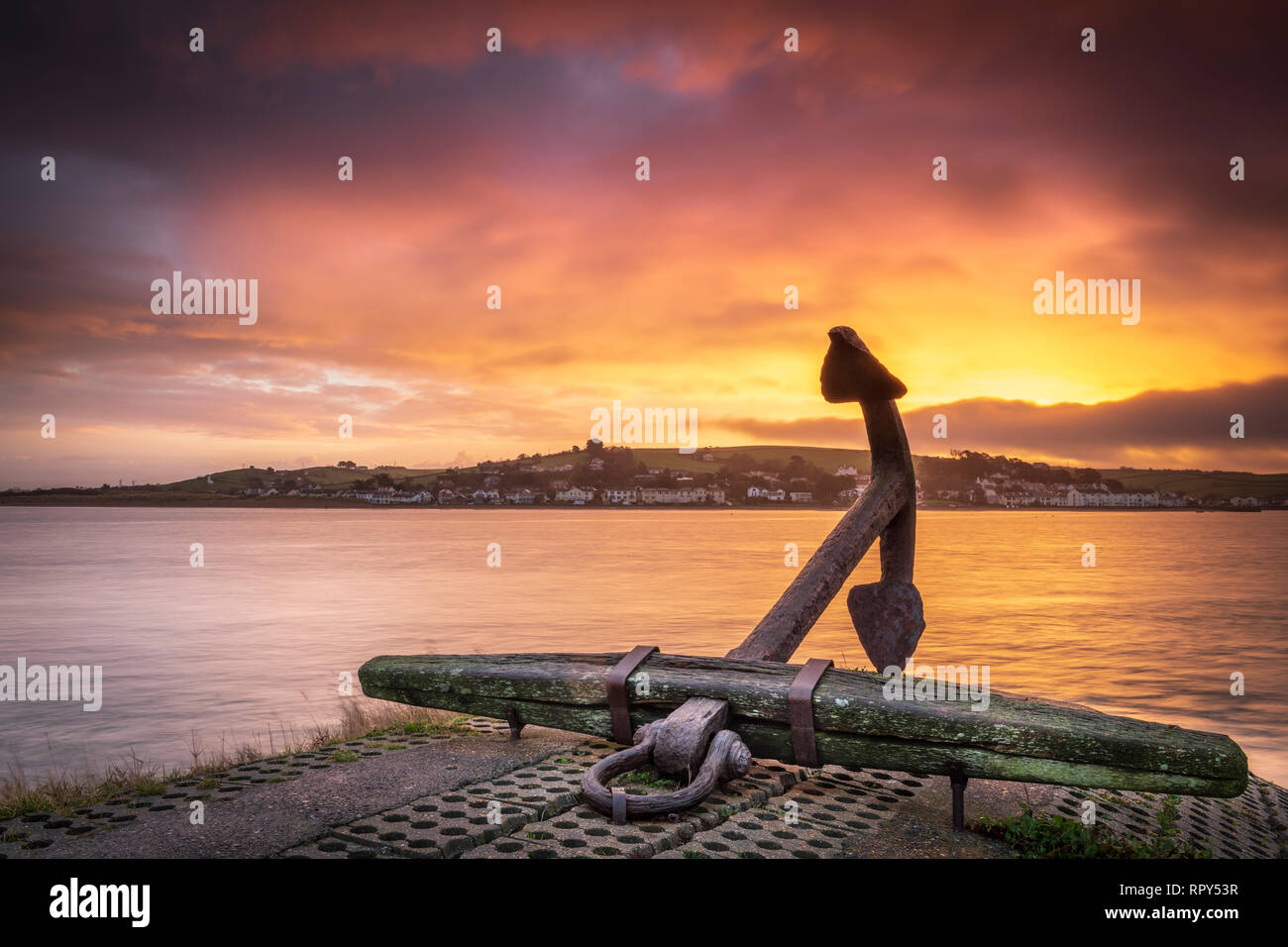 The landmark anchor on the quayside at sunrise in the beautiful North Devon Village of Appledore. Stock Photo