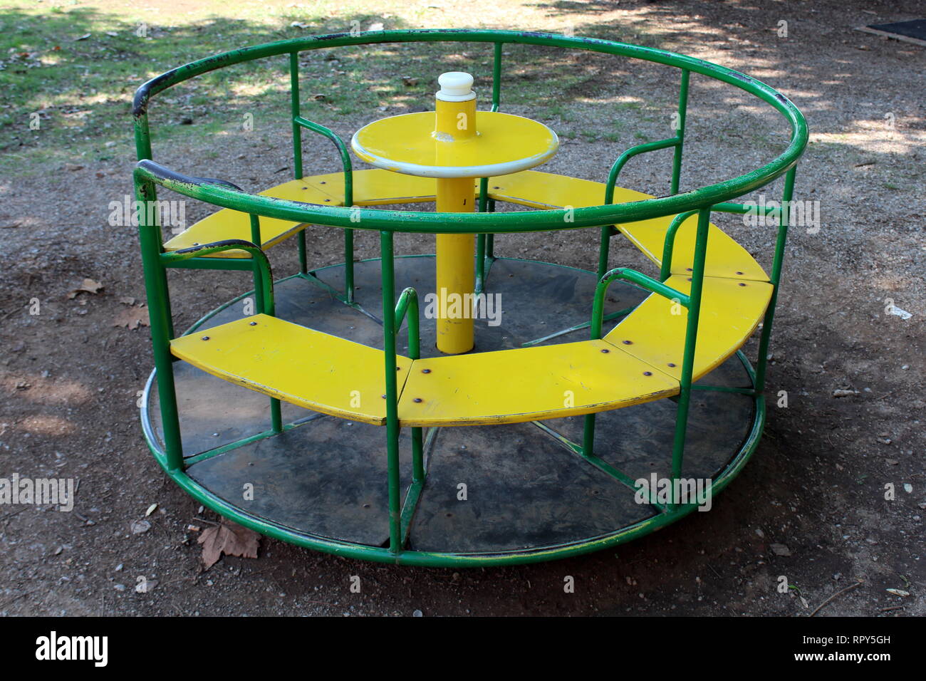 Old colorful outdoor public playground equipment made of metal and wood