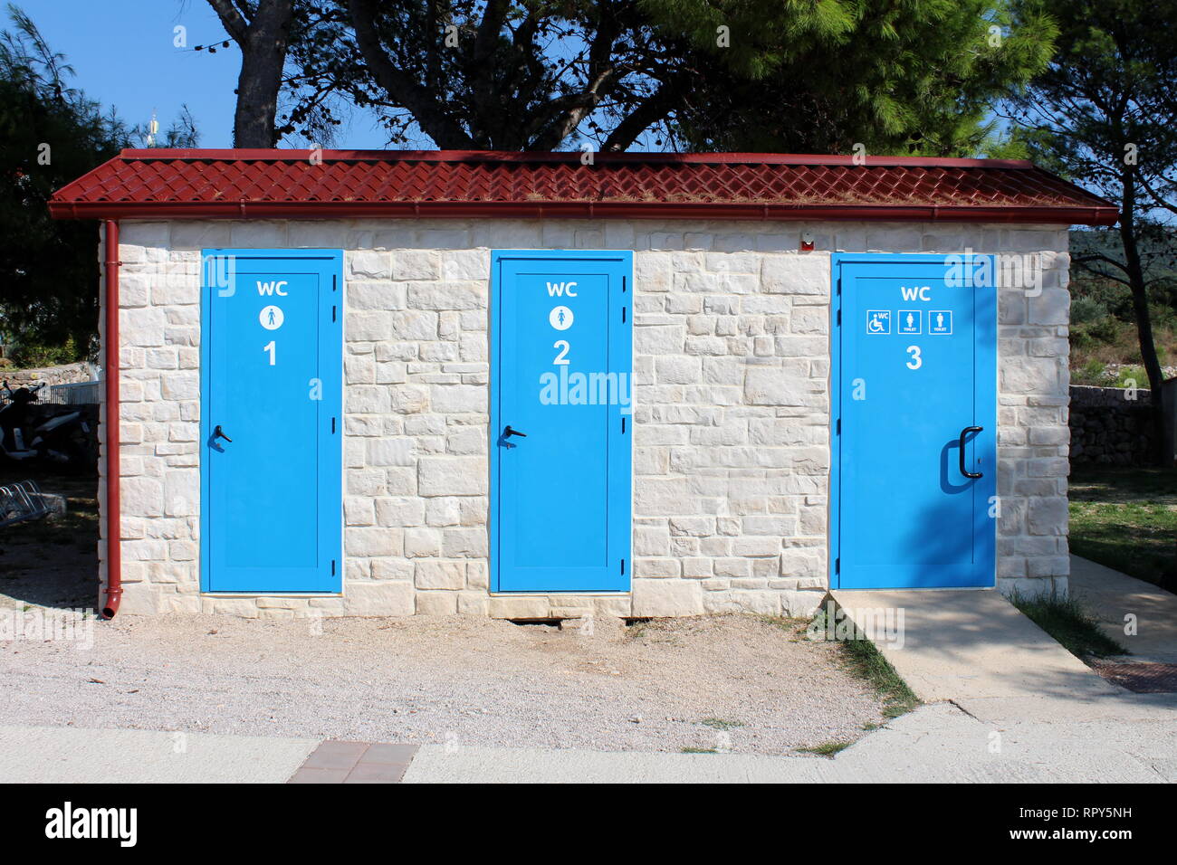 Outdoor public beach toilets in a row for men woman and disabled persons in  well built new traditional stone structure surrounded with gravel Stock  Photo - Alamy