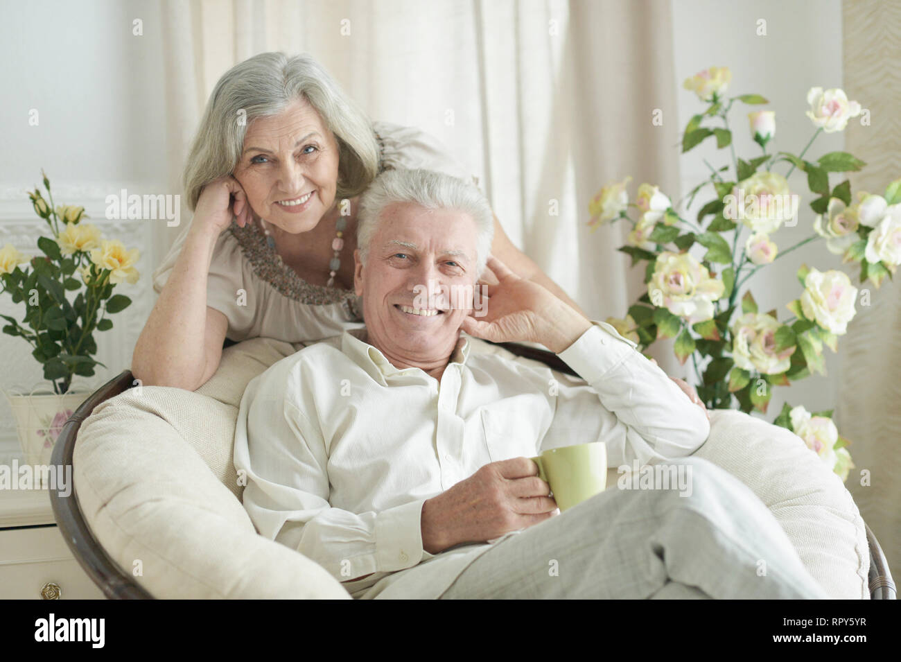 Portrait of two elderly people resting at home with tea Stock Photo