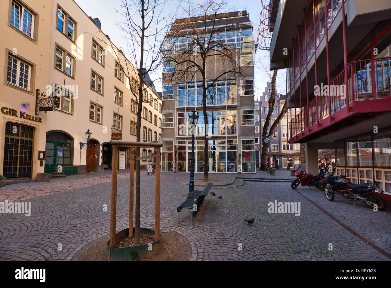 Cologne, GERMANY - February 15, 2019: Many unidentified individuals enjoy the warm sundown in the historic old town. Stock Photo