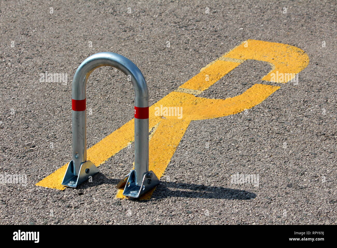 Shiny metal fold down vehicle security car parking lock safety barrier  mounted on paved parking lot with reserved sign painted on asphalt Stock  Photo - Alamy