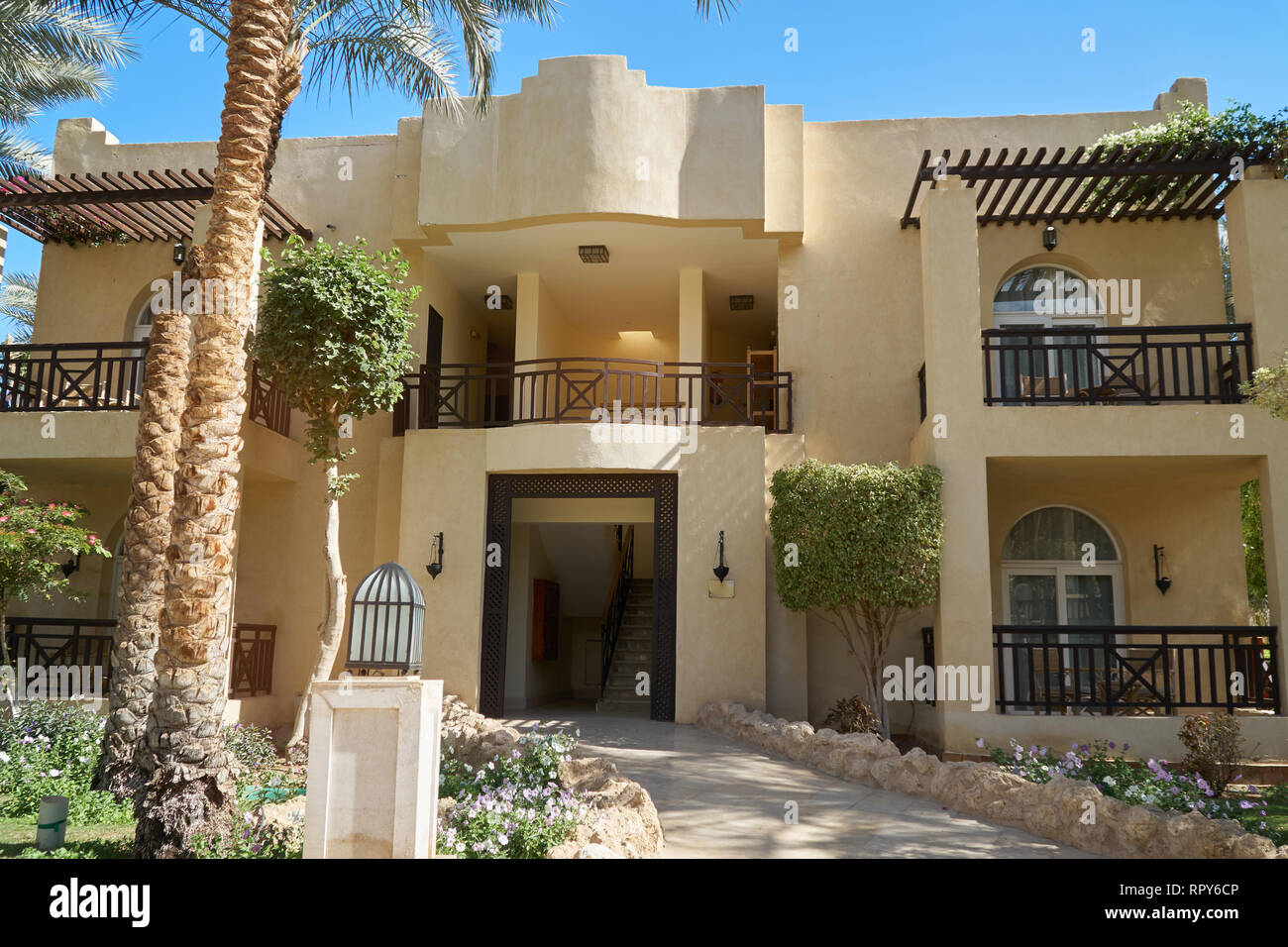 Sharm El Sheikh, Egypt - February 9, 2019: Five-star The Grand Hotel with palms Footpath between green grass in territory summer Stock Photo