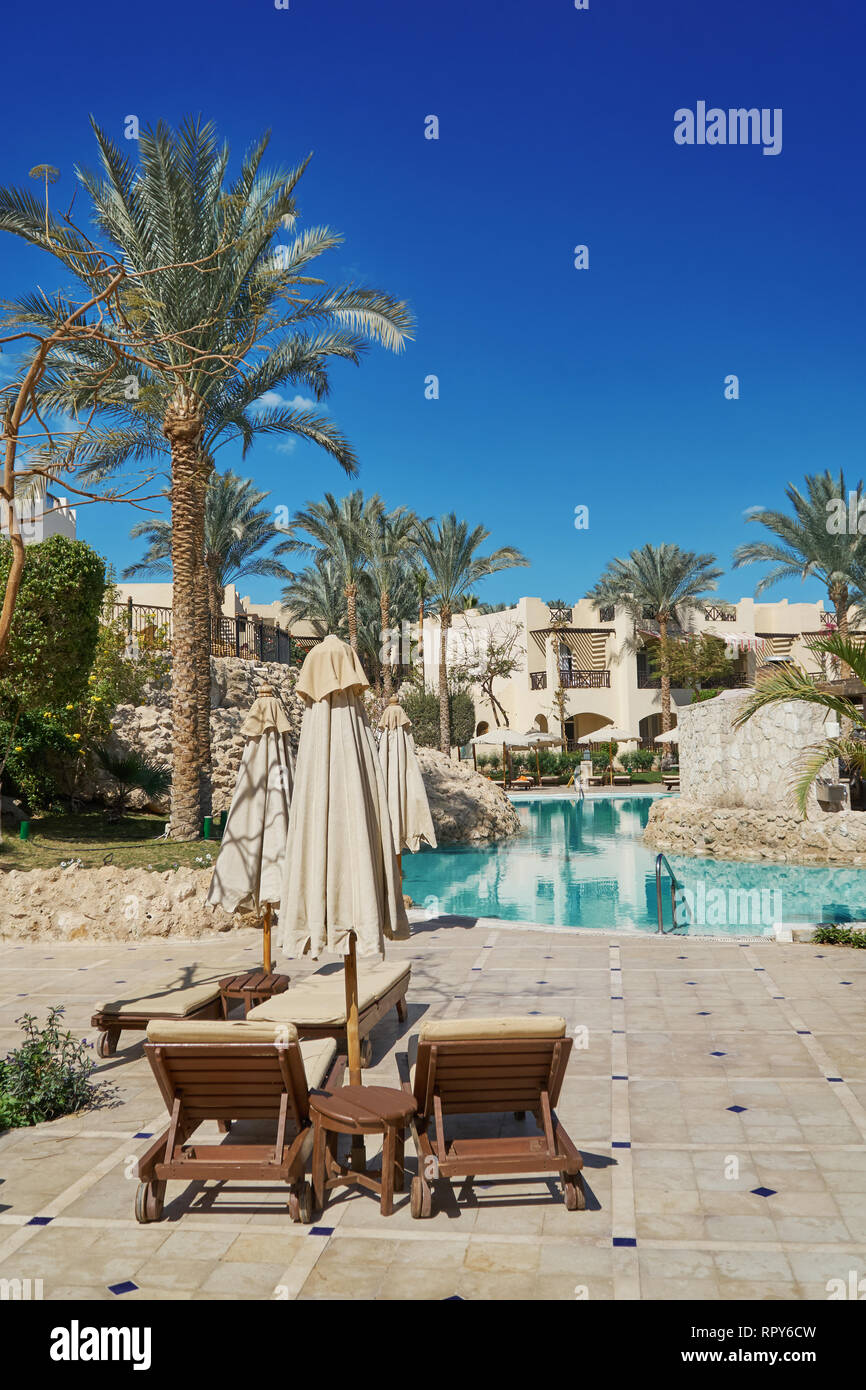 Sharm El Sheikh, Egypt - February 9, 2019: Five-star The Grand Hotel with palms and loungers near swimming pool in territory summer Stock Photo