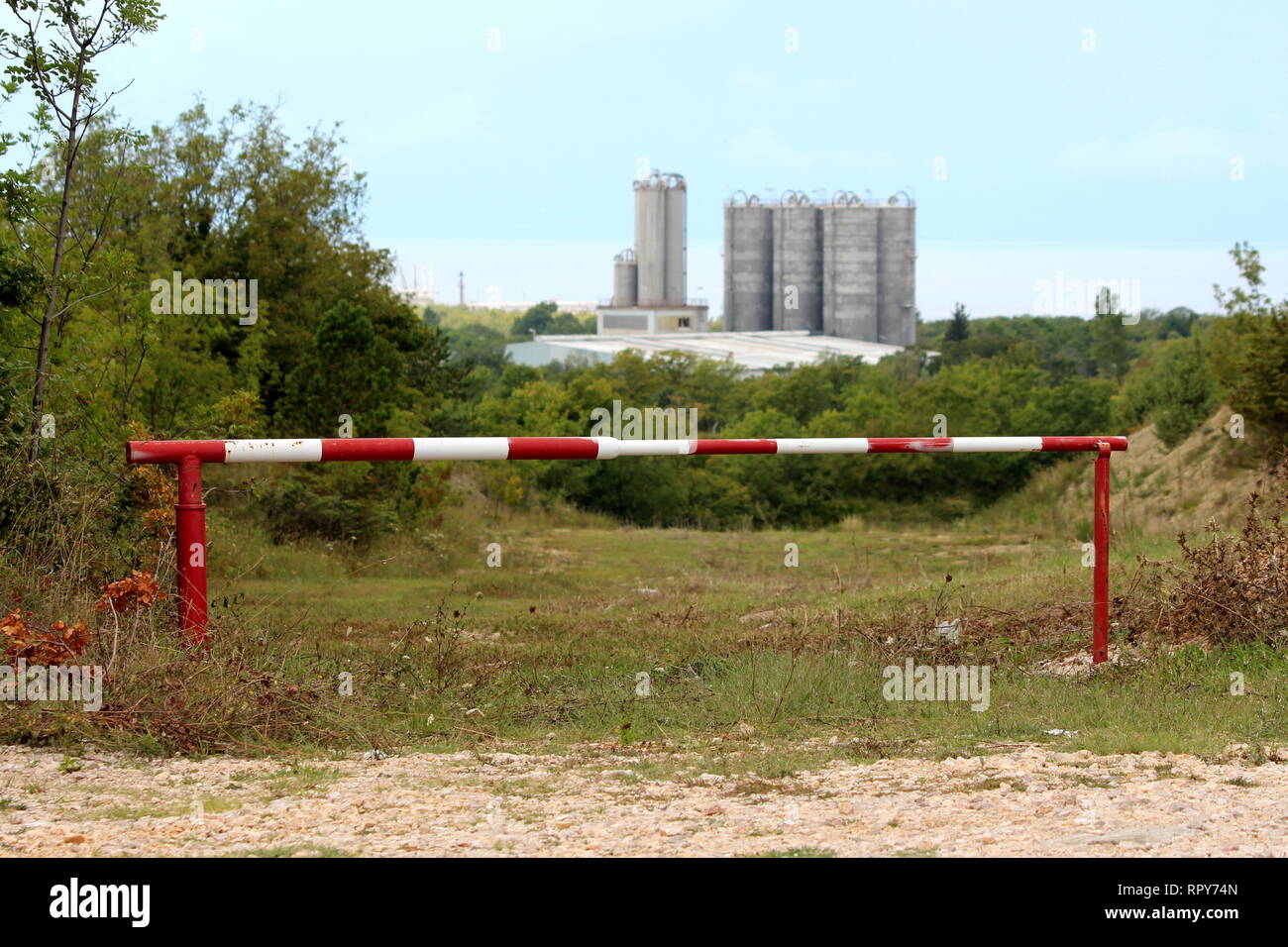 Unlocked metal red and white ramp preventing access to road leading ...